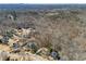 A panoramic aerial view captures the property's location nestled amongst lush woodland areas at 1043 Sugar Pike Way, Canton, GA 30115