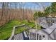 Multi-level deck with stairs leading to a large grassy backyard surrounded by woods at 1043 Sugar Pike Way, Canton, GA 30115