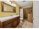Bathroom featuring dark wood cabinets, single sink vanity, and shower with built-in seating at 1043 Sugar Pike Way, Canton, GA 30115