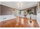 Elegant dining room featuring hardwood floors, wainscoting, crown molding and a chandelier at 1043 Sugar Pike Way, Canton, GA 30115