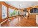 Bright dining room boasts hardwood floors, large windows, and decorative chandelier at 1043 Sugar Pike Way, Canton, GA 30115