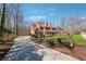 Beautiful two-story home with a spacious driveway and well-maintained landscaping and charming front porch at 1043 Sugar Pike Way, Canton, GA 30115