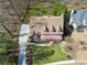 A charming two-story home features a long driveway, mature trees, and well-manicured landscaping at 1043 Sugar Pike Way, Canton, GA 30115
