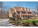 Lovely two-story home with a covered front porch, well-manicured lawn, and a brick and siding exterior at 1043 Sugar Pike Way, Canton, GA 30115