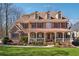 Charming brick two-story home with a welcoming front porch and manicured lawn at 1043 Sugar Pike Way, Canton, GA 30115