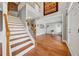 Spacious foyer with hardwood floors, a staircase, and a view into the formal living room at 1043 Sugar Pike Way, Canton, GA 30115
