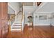 Elegant foyer with hardwood floors, a staircase with white railings, and neutral gray walls at 1043 Sugar Pike Way, Canton, GA 30115