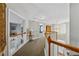 Upstairs hallway with wood railing and a view of the foyer at 1043 Sugar Pike Way, Canton, GA 30115