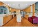 Well-lit kitchen with stainless appliances, island, and hardwood floors throughout at 1043 Sugar Pike Way, Canton, GA 30115