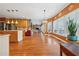 Open kitchen with stainless appliances, hardwood floors, island, and adjacent dining area at 1043 Sugar Pike Way, Canton, GA 30115
