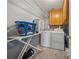 Functional laundry room equipped with a washer, dryer, shelving, and an ironing board at 1043 Sugar Pike Way, Canton, GA 30115