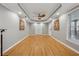 This living room features wood floors, recessed lights, windows, a ceiling fan, and neutral colors at 1043 Sugar Pike Way, Canton, GA 30115
