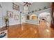 Open-concept living room with hardwood floors, neutral colors, and archways leading to other rooms at 1043 Sugar Pike Way, Canton, GA 30115