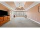 Large main bedroom featuring tray ceiling, carpet floors and a large window view at 1043 Sugar Pike Way, Canton, GA 30115