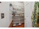 Walk-in pantry with white wire shelving, wood floors, and a light switch by the door at 1043 Sugar Pike Way, Canton, GA 30115
