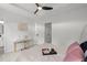 Modern bedroom includes neutral colors, art, and a desk area near the ensuite bathroom at 112 Timber Mist Ln, Lawrenceville, GA 30045