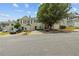 Charming street view of townhouses featuring green shutters and manicured lawns on a sunny day at 112 Timber Mist Ln, Lawrenceville, GA 30045