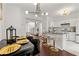 Modern kitchen with a breakfast bar, stylish pendant lighting, and an adjacent dining area for easy entertaining at 112 Timber Mist Ln, Lawrenceville, GA 30045