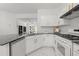 Bright kitchen boasts white cabinets, black counters, and modern stainless steel appliances at 112 Timber Mist Ln, Lawrenceville, GA 30045