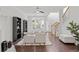 Bright living room with modern furnishings, hardwood floors, and large windows offering ample natural light at 112 Timber Mist Ln, Lawrenceville, GA 30045