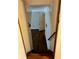 Stairwell leading down to basement with dark wood-look flooring and white walls at 2102 Bedford Ct, Lithonia, GA 30058