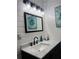 Modern bathroom features a marble countertop, black faucet, and stylish light fixture at 2102 Bedford Ct, Lithonia, GA 30058
