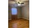 Bedroom featuring a ceiling fan, window with curtain, and hardwood floors at 2102 Bedford Ct, Lithonia, GA 30058