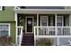 Inviting front porch showcasing decorative details and a cozy seating area, perfect for relaxing outdoors at 2102 Bedford Ct, Lithonia, GA 30058