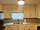 Kitchen featuring a stainless steel sink, gray subway tile backsplash, and granite countertops at 2102 Bedford Ct, Lithonia, GA 30058