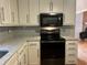 Modern kitchen features stainless steel appliances, white cabinets and light backsplash at 2102 Bedford Ct, Lithonia, GA 30058