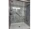 This bathroom showcases a sleek shower with a modern, marble-patterned surround and glass door at 2102 Bedford Ct, Lithonia, GA 30058