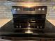 Close up view of the stainless steel stove top and gray subway tile backsplash at 2102 Bedford Ct, Lithonia, GA 30058
