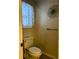 Cozy powder room displaying a classic toilet with a window and decorative wall art at 2102 Bedford Ct, Lithonia, GA 30058