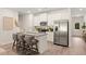 Modern kitchen island with seating, stainless steel appliances, and white cabinetry at 328 Sinclair Ct # 78, Mcdonough, GA 30253