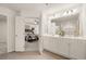 Elegant bathroom with double vanity, white cabinets, decorative accents, and access to the main bedroom at 344 Sinclair Ct # 74, Mcdonough, GA 30253