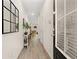 Welcoming hallway featuring wood-look flooring, contemporary decor, and a clear view into the home's living spaces at 344 Sinclair Ct # 74, Mcdonough, GA 30253