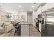 Open-concept living space featuring a kitchen island with seating, dining area, and a comfortable sofa at 344 Sinclair Ct # 74, Mcdonough, GA 30253