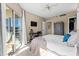 Bright bedroom with a king-size bed, a workstation, and sliding doors to the private balcony at 1 Biscayne Nw Dr # 804, Atlanta, GA 30309