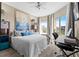 Cozy bedroom featuring a king-size bed, a desk area, and sliding doors to a private balcony at 1 Biscayne Nw Dr # 804, Atlanta, GA 30309
