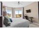 Bright bedroom featuring a king-size bed, a workstation, and sliding doors to a private balcony at 1 Biscayne Nw Dr # 804, Atlanta, GA 30309