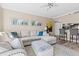 Comfortable living room featuring a sectional sofa, contemporary artwork, and access to the kitchen at 1 Biscayne Nw Dr # 804, Atlanta, GA 30309
