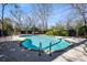 Community pool surrounded by lush landscaping and an iron fence, providing a relaxing and private oasis at 1 Biscayne Nw Dr # 804, Atlanta, GA 30309