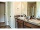 Bathroom featuring a double sink vanity, granite countertops, and decorative mirror provide ample space and style at 1291 Vienna Ct, Hampton, GA 30228