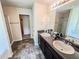 Bathroom featuring a double sink vanity, granite countertops, and decorative mirror provide ample space and style at 1291 Vienna Ct, Hampton, GA 30228