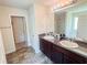 Bathroom featuring a double sink vanity, granite countertops, and decorative mirror provide ample space and style at 1291 Vienna Ct, Hampton, GA 30228