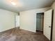A bedroom with a walk-in closet to maximize space, and a door leading to another room in the house at 1291 Vienna Ct, Hampton, GA 30228
