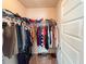 Walk-in closet filled with clothing, showing ample hanging space at 1291 Vienna Ct, Hampton, GA 30228