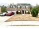 Charming two-story brick home featuring a two-car garage and well-manicured lawn at 1291 Vienna Ct, Hampton, GA 30228