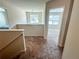 The house hallway features a chandelier, window, bedrooms, and carpeted floors to provide an aesthetic appeal at 1291 Vienna Ct, Hampton, GA 30228