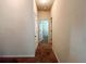 Neutral hallway leads to rooms, with carpeted floors and white walls, offering a clean transition at 1291 Vienna Ct, Hampton, GA 30228